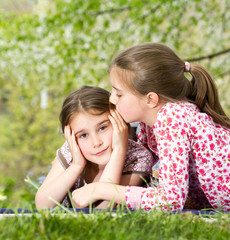 Two little sisters spending time together in spring day