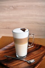 Latte Macchiato In Glass Cup On The Wooden Table    