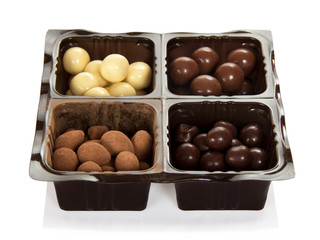 Chocolate candies in plastic container