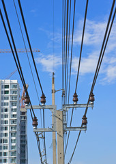 Electricity post and cable line with blue sky