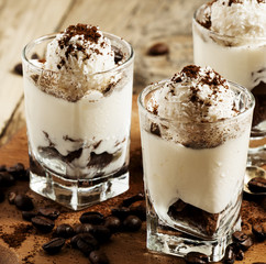 Traditional Italian dessert tiramisu in glass, selective focus