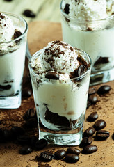 Traditional Italian dessert tiramisu in glass, selective focus