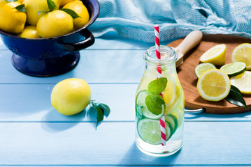 Lemon water in glass on blue wooden table