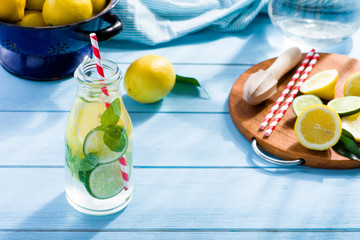 Lemon water in glass on blue wooden table