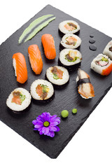 Sushi on black stone plate isolated top view