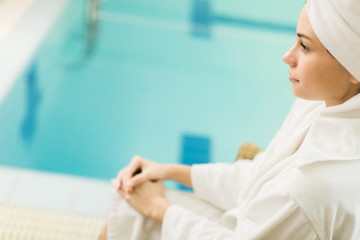 Fototapeta premium Young woman by the pool