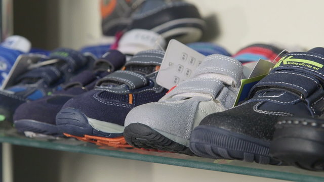 Dolly: Shelf  with shoes for kids in the children shoe store