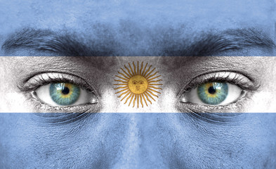 Naklejka premium Human face painted with flag of Argentina