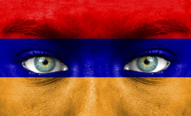 Human face painted with flag of Armenia