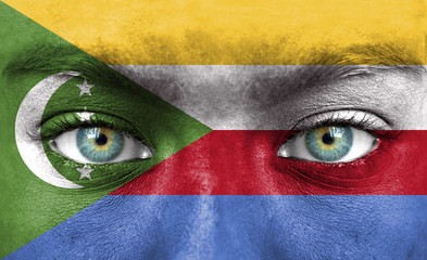 Human face painted with flag of Comoros