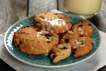 Cookies on plate with condensed milk on table close up