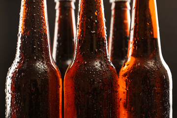 Glass bottles of beer on dark background