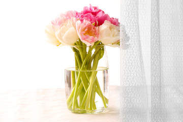 Bouquet of fresh tulips on curtain background