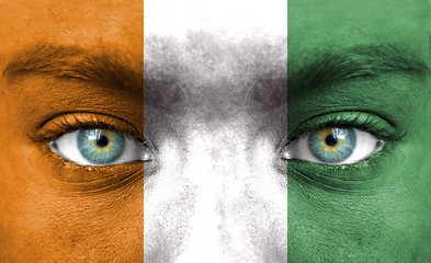 Human face painted with flag of Ivory Coast