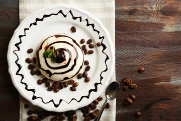 Tasty panna cotta dessert on plate, on wooden table - obrazy, fototapety, plakaty
