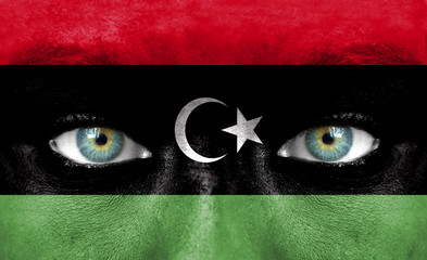 Human face painted with flag of Libya