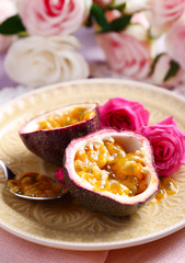 Passion fruit on plate on color wooden background
