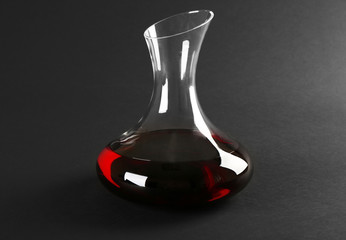 Glass carafe of wine on dark background