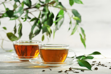 Cups of green tea on table on wooden background