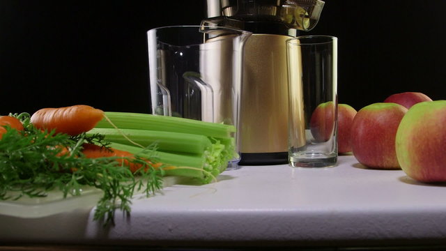 making freshly squeezed juice carrot apple and celery
