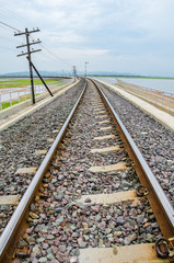 Fototapeta premium Railroad tracks into the reservoir, Lopburi Thailand. 