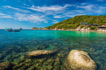 Rock beach and blue sky with beautiful clouds tropical sea