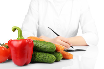 Nutritionist doctor writing  diet plan, isolated on white