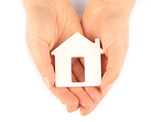 Female hands with model of house isolated on white
