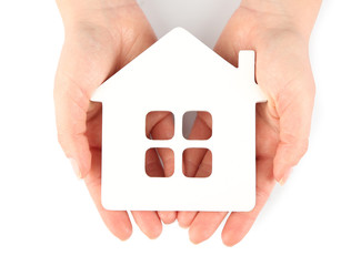 Female hands with model of house isolated on white