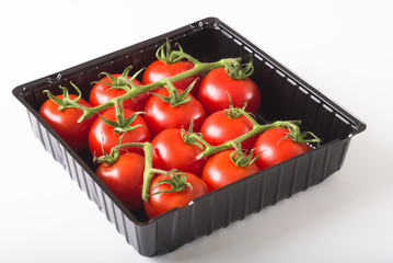 Aerial view fresh red tomatoes in black plastic tray - 83279233