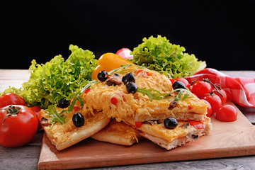 Delicious homemade pizza on table on black background
