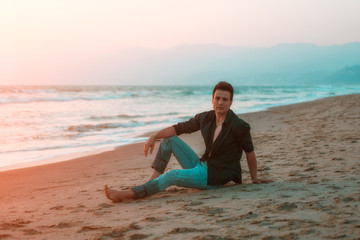 Handsome sexy and serious man relaxing at beach.