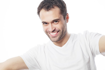 young man holding camera and making selfie 