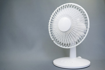 Rotating electric fan on gray background