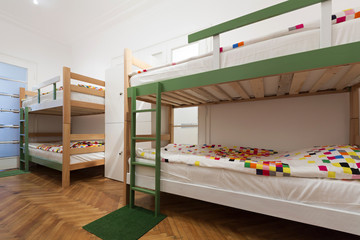 Bunk beds in a hostel room - obrazy, fototapety, plakaty