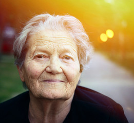 Portrait of happy older lady outdoors - 83286001