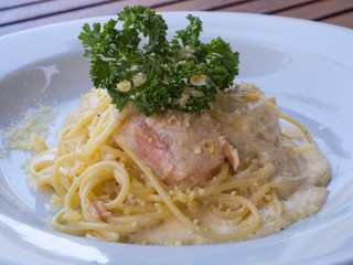 Spaghetti with fish on white dish