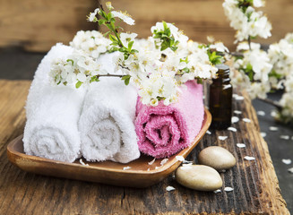 Fototapeta na wymiar Spa Setting with Cotton Towels and Flowers
