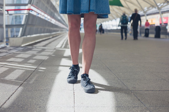 Legs of young woman walking in station