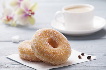 Fresh donut served with a cup of coffee