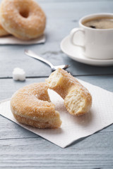 Fresh donut served with a cup of coffee