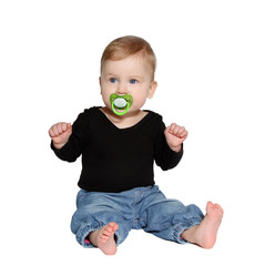 baby sits with green pacifier in mouth