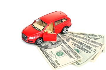 Toy car and money over white.