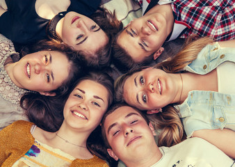 Teenage friends lying together in circle