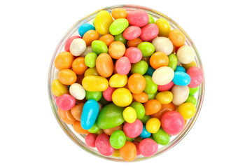 Colorful candies in glass bowl isolated on white