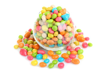 Colorful candies in glass bowl isolated on white