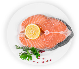 Raw salmon steak with lemon.