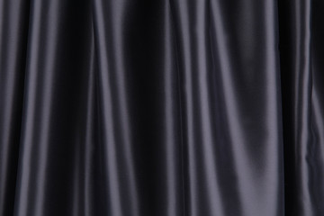 Soft folds of black silk cloth.