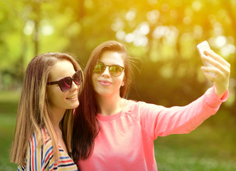 Friends making selfie on beautiful summer day in park