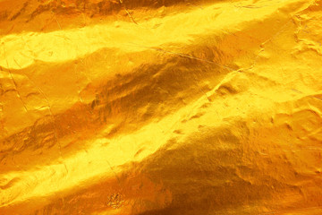 Shiny yellow leaf dark gold foil texture background